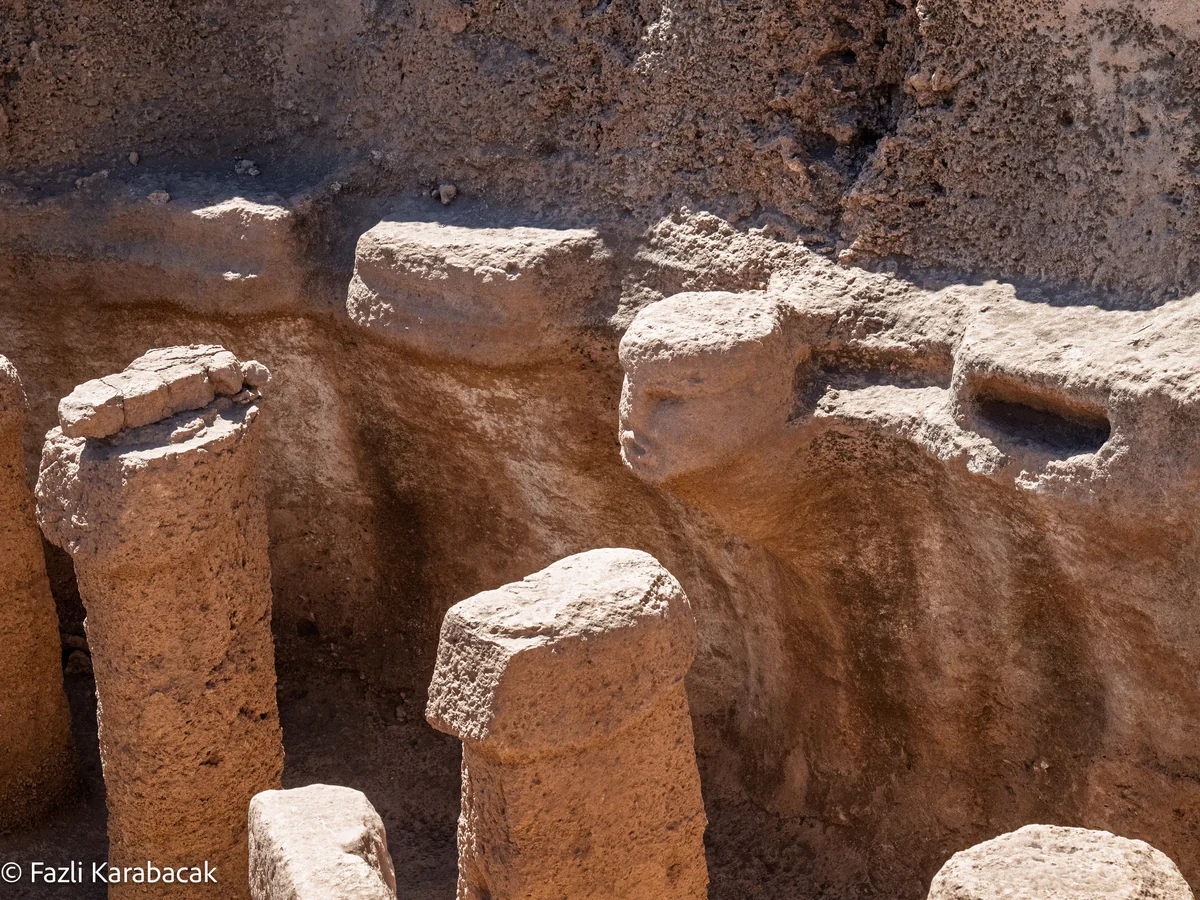 The carved human figure rising from bedrock at the centre of Structure AB Karahantepe